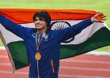 Gold medallist Neeraj Chopra poses for photographs at the medal ceremony of the men's javelin throw event of the Asian Games