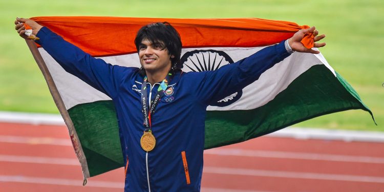 Gold medallist Neeraj Chopra poses for photographs at the medal ceremony of the men's javelin throw event of the Asian Games