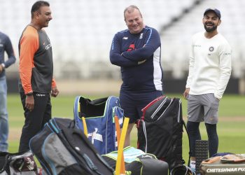 India coach Ravi Shastri (L) and skipper Virat Kohli (R), laugh their disappointments out during India’s training session at Trent Bridge, Friday  