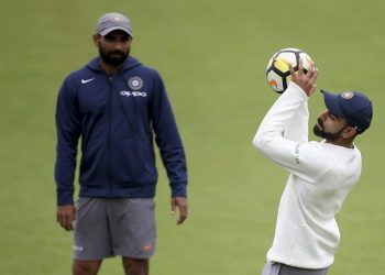 Virat Kohli catches a soccer ball as Mohammed Shami looks on during a nets session in Southampton, Wednesday