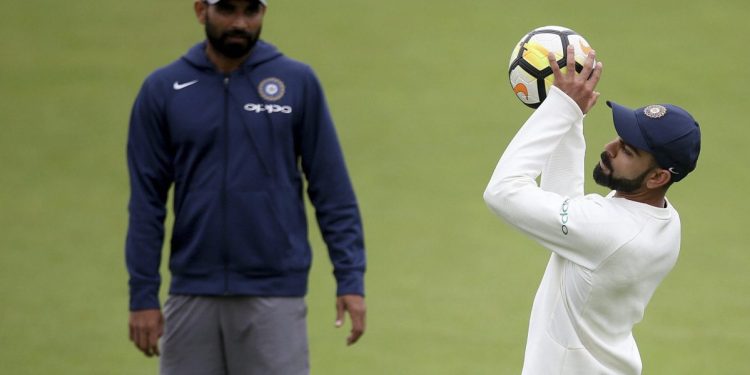 Virat Kohli catches a soccer ball as Mohammed Shami looks on during a nets session in Southampton, Wednesday