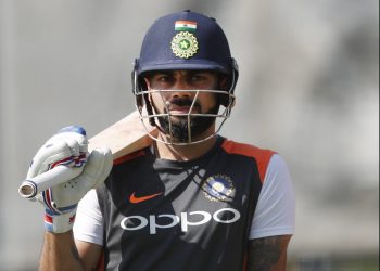 Virat Kohli waits for his chance at the nets during India's practice session