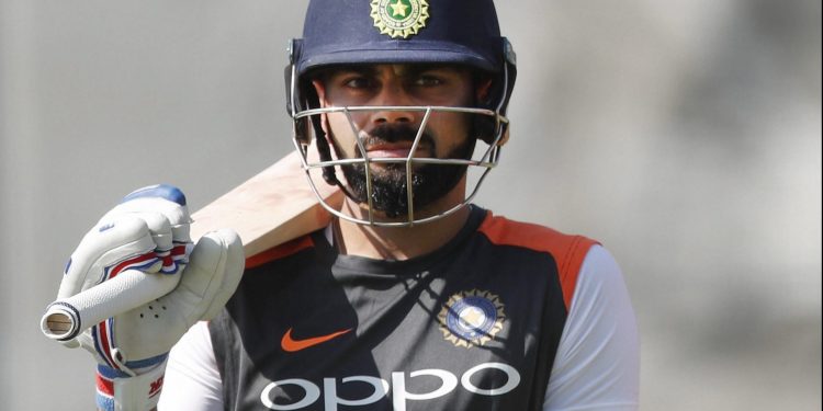 Virat Kohli waits for his chance at the nets during India's practice session