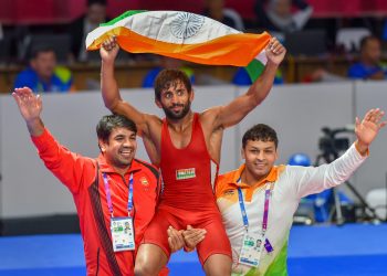 Bajrang Punia carries the tricolour after winning gold in men's freestyle wrestling (65kg) event at the Asian Games