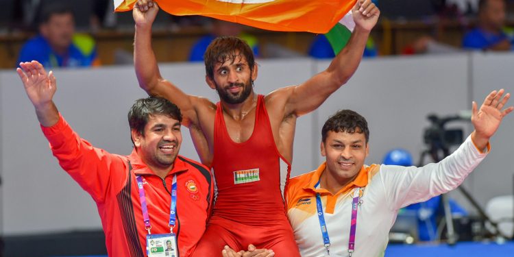 Bajrang Punia carries the tricolour after winning gold in men's freestyle wrestling (65kg) event at the Asian Games