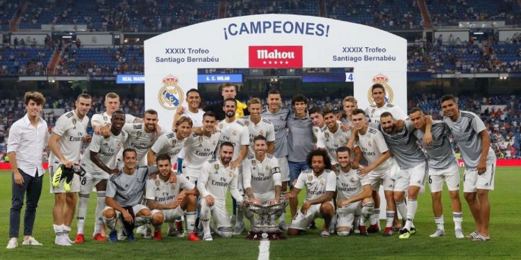 Real Madrid players pose with the Santiago Bernabeu trophy in Madrid, Saturday  