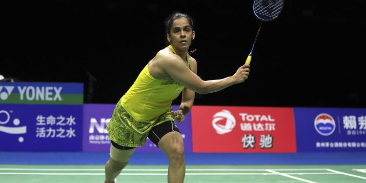Saina Nehwal of India accidentally hits the shuttlecock out of play as she competes against Carolina Marin of Spain in their women's singles quarterfinal match at the Badminton World Championships in Nanjing, China, Friday