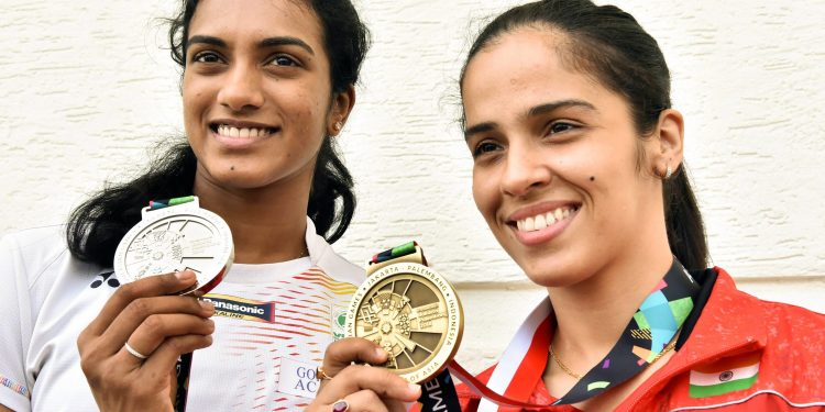 Indian shuttlers at Asian Games Silver medallist PV Sindhu and Bronze medallist Saina Nehwal pose for a photo after a press conference in Hyderabad