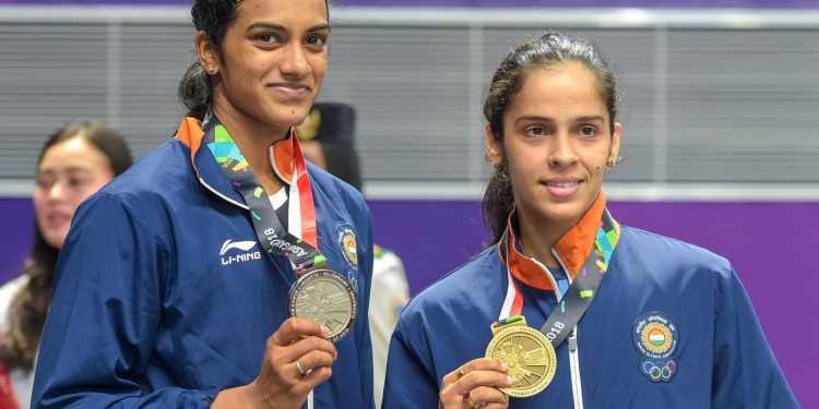 PV Sindhu (L) and Saina Nehwal pose with their badminton singles silver and bronze medals respectively