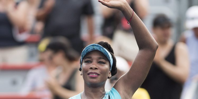 Venus Williams waves to the crowd following her win over Caroline Dolehide at Montreal, Monday