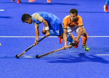 India's Vivek Prasad (L) tries to hit the ball during their men's hockey semifinal match against Malaysia at the Asian Games