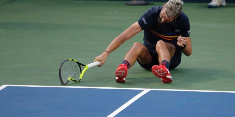 Benot Paire hurls his racqet on the court after losing to Marcos Baghdatis at the Washington Open