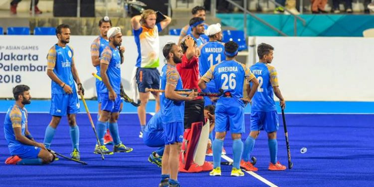 Indian hockey team look on after being defeated by Malaysian in the semifinal match of Asian Games