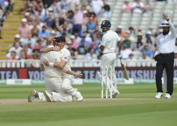 James Anderson hugs bowler Ben Stokes as the umpire rules Virat Kohli out at Edgbaston, Saturday