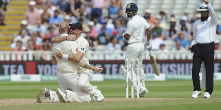 James Anderson hugs bowler Ben Stokes as the umpire rules Virat Kohli out at Edgbaston, Saturday