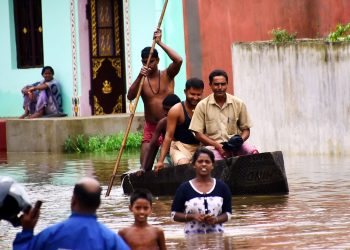 Residents of Sujata Nagar in Puri travel in a boat, Tuesday