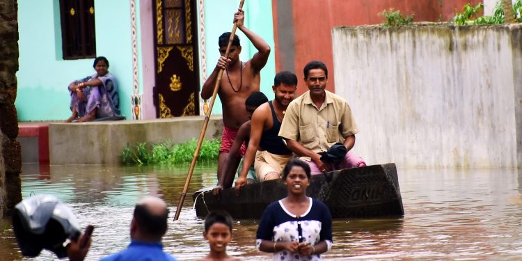 Residents of Sujata Nagar in Puri travel in a boat, Tuesday