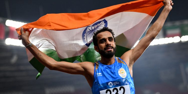 Manjit Singh of India celebrates victory after winning Men's 800m at the Asian Games