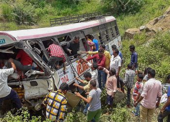 Rescue officials at the accident site where a state-owned Road Transport Corporation bus skidded into a deep gorge, at Jagtial district, Tuesday