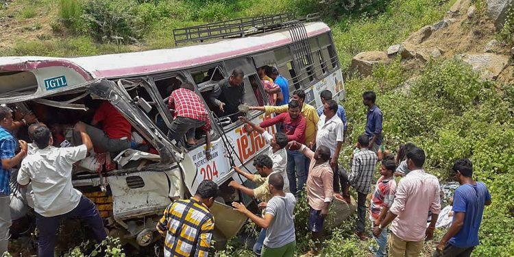 Rescue officials at the accident site where a state-owned Road Transport Corporation bus skidded into a deep gorge, at Jagtial district, Tuesday