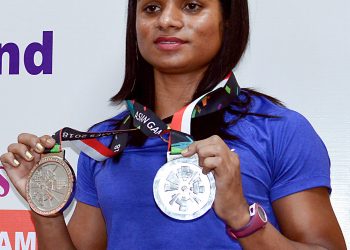 Asian Games winner Indian Athlete Dutee Chand displays her medals during an event, in Bangalore