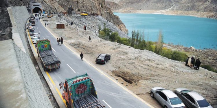 To go with story 'Pakistan-China-economy-transport, FEATURE' by Guillaume LAVALLÉE
In this photograph taken on September 29, 2015, Pakistani commuters wait to travel through a newly built tunnel in northern Pakistan's Gojal Valley.  A glossy highway and hundreds of lorries transporting Chinese workers by the thousands: the new Silk Road is under construction in northern Pakistan, but locals living on the border are yet to be convinced they will receive more from it than dust.    AFP PHOTO / Aamir QURESHI