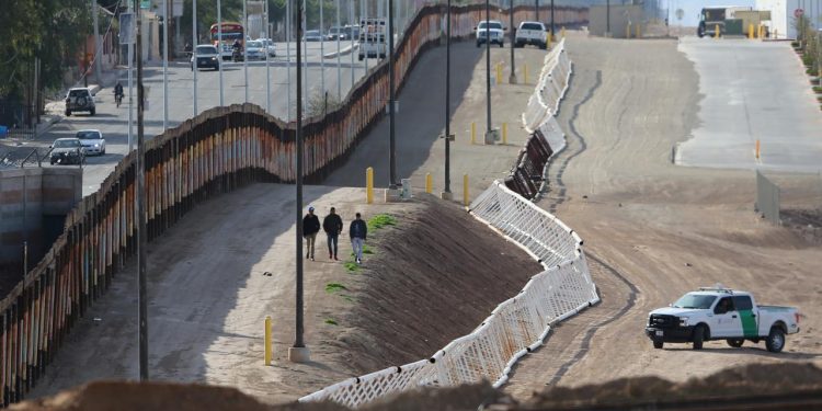 Three men from India jump the fence from Mexico and give themselves up to U.S. border patrol agents in Calexico, California, U.S. February 8, 2017. REUTERS/Mike Blake/Files