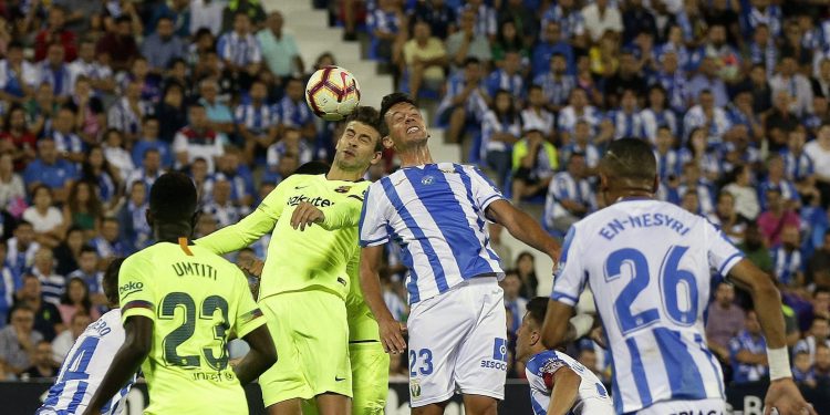 Barcelona’s Gerard Pique (top left) duels for the ball against Leganes Mikel Vesga at Butarque stadium in Leganes, Spain, Wednesday   