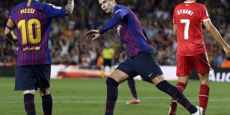 Lionel Messi joins Gerard Pique (C) while the latter wheels away for celebration after scoring Barcelona’s equaliser against Girona, Sunday 