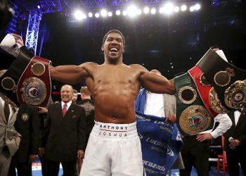 Anthony Joshua celebrates after defeating Alexander Povetkin to retain his heavyweight boxing titles in London, Saturday    

       