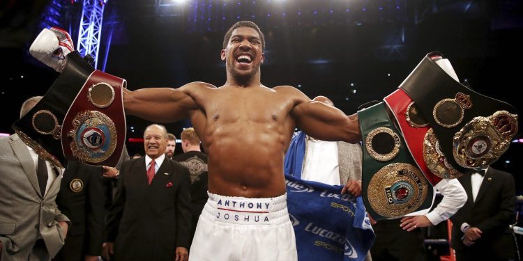 Anthony Joshua celebrates after defeating Alexander Povetkin to retain his heavyweight boxing titles in London, Saturday    

       