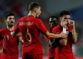 Pepe (R) celebrates with teammates after scoring against Croatia