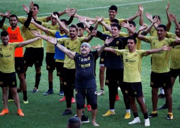 Diego Maradona sings with the Dorados players and fans (not in picture) on his first practice session with the team