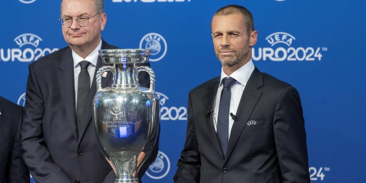 German Football Association president Reinhard Grindel (L) and UEFA president Aleksander Ceferin pose with the UEFA Euro trophy after Germany won the bid to host Euro 2024  