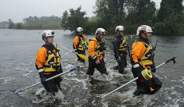 FAIRFIELD HARBOUR, NC - SEPTEMBER 14:  Members of the FEMA Urban Search and Rescue Task Force 4 from Oakland, California, search a flooded neighborhood for evacuees during Hurricane Florence September 14, 2018 in Fairfield Harbour, North Carolina. Hurricane Florence made landfall in North Carolina as a Category 1 storm and flooding from the heavy rain is forcing hundreds of people to call for emergency rescues in the communities around New Bern, North Carolina, which sits at the confluence of the Neuse and Trent rivers.  (Photo by Chip Somodevilla/Getty Images)