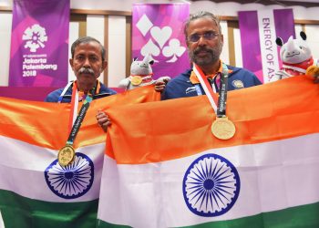 Gold medallist India's Pranab Bardhan and Shibhnath Sarkar pose with the Indian tricolour after winning in bridge competition at the Asian Games