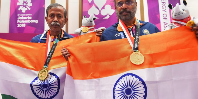 Gold medallist India's Pranab Bardhan and Shibhnath Sarkar pose with the Indian tricolour after winning in bridge competition at the Asian Games
