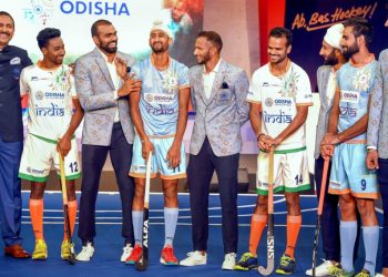 Indian men's hockey team players and coach Harendra Singh (L) during the launch of new home and away kit for the World Cup