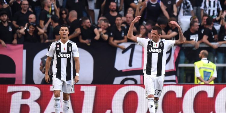Cristiano Ronaldo (L) looks on as Mario Mandzukic celebrates after scoring against Napoli, Saturday