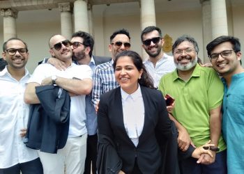 Keshav Suri, one of the petitioners and executive director of Lalit Group of Hotels, kisses his French partner Cyril Feuillebois, following the judgement in New Delhi, Thursday. Also seen among others are writer Devdutt Pattanaik (in green shirt) and advocate Neha Nagpal