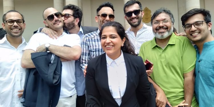 Keshav Suri, one of the petitioners and executive director of Lalit Group of Hotels, kisses his French partner Cyril Feuillebois, following the judgement in New Delhi, Thursday. Also seen among others are writer Devdutt Pattanaik (in green shirt) and advocate Neha Nagpal