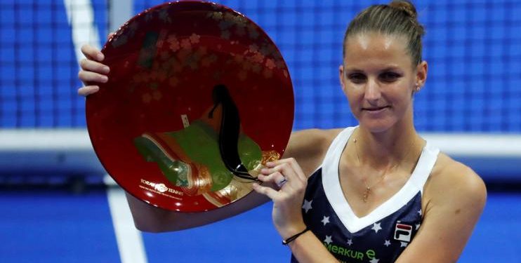 Karolina Pliskova holds the Pan Pacific Open winner's trophy after defeating Noami Osaka in final