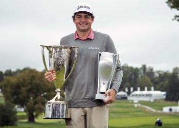 Keegan Bradley poses with the two trophies following the BMW Championship golf tournament at the Aronimink Golf Club