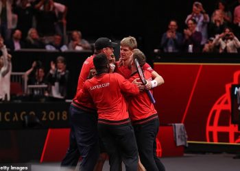 Team World players hug Kevin Anderson (right) after his stunning win over Novak Djokovic at Chicago, Saturday 