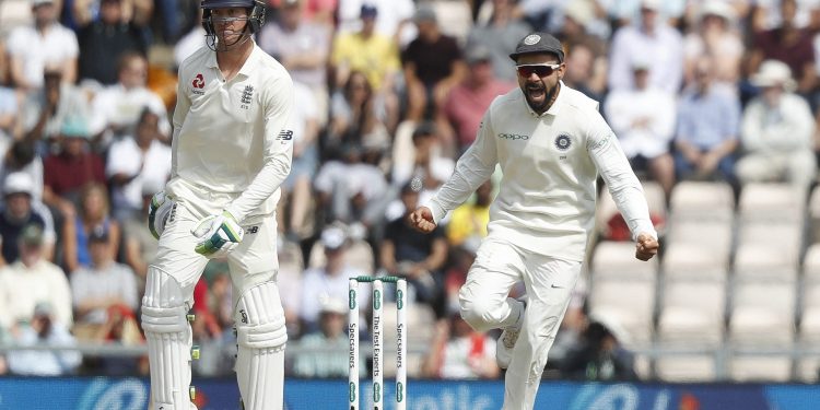 Virat Kohli (R) celebrates after England's Keaton Jennings was given out lbw off the bowling of Mohammed Shami during play on the third day of the 4th Test match