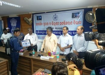 A visually-challenged student being given laptop in presence of SSEPD Minister Prafulla Samal (3rd from R) at National Career Service Centre for the Differently-Abled in Bhubaneswar, Wednesday
