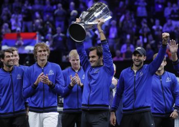 Team Europe’s Roger Federer hoists the winners’ trophy as he celebrates with teammates after defeating Team World in the Laver Cup tennis tournament in Chicago, Sunday   