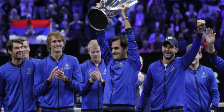 Team Europe’s Roger Federer hoists the winners’ trophy as he celebrates with teammates after defeating Team World in the Laver Cup tennis tournament in Chicago, Sunday   