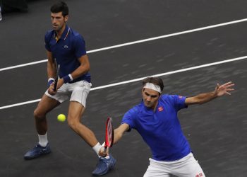 Team Europe's Roger Federer (R) and Novak Djokovic play against Team World's Jack Sock and Kevin Anderson during a men's doubles tennis match at the Laver Cup, Friday