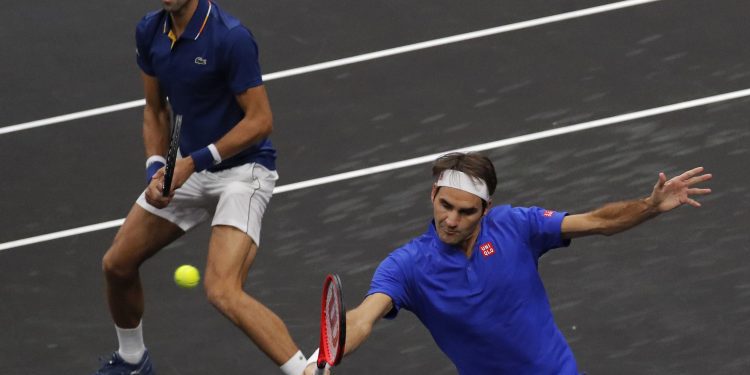 Team Europe's Roger Federer (R) and Novak Djokovic play against Team World's Jack Sock and Kevin Anderson during a men's doubles tennis match at the Laver Cup, Friday